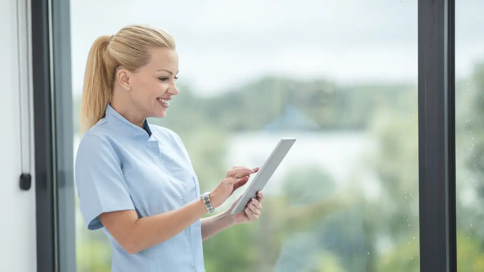 Nurse checking a list on a tablet
