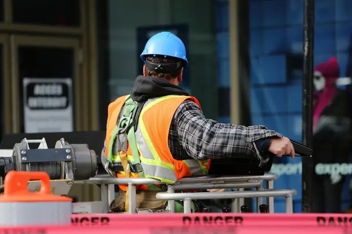 Construction worker in hi-vis and a hard hat on a building site