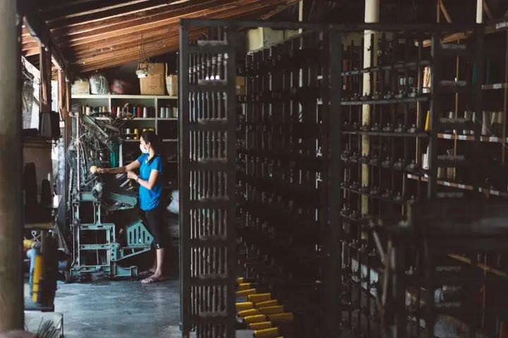 Worker picking stock from warehouse racking