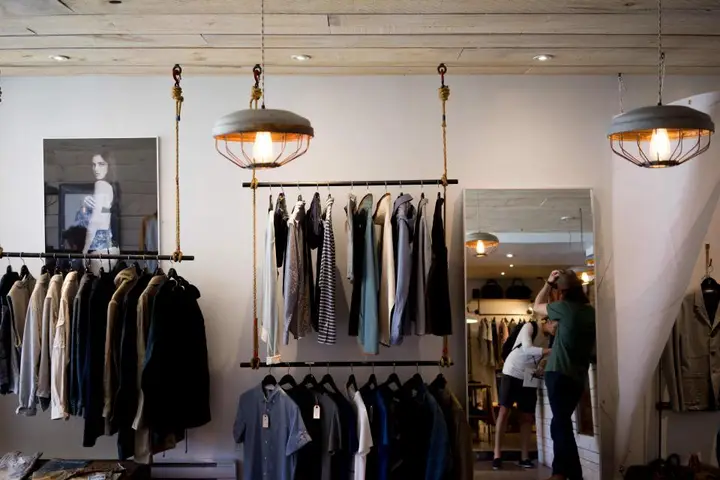 Clothing store with racks under pendant lights